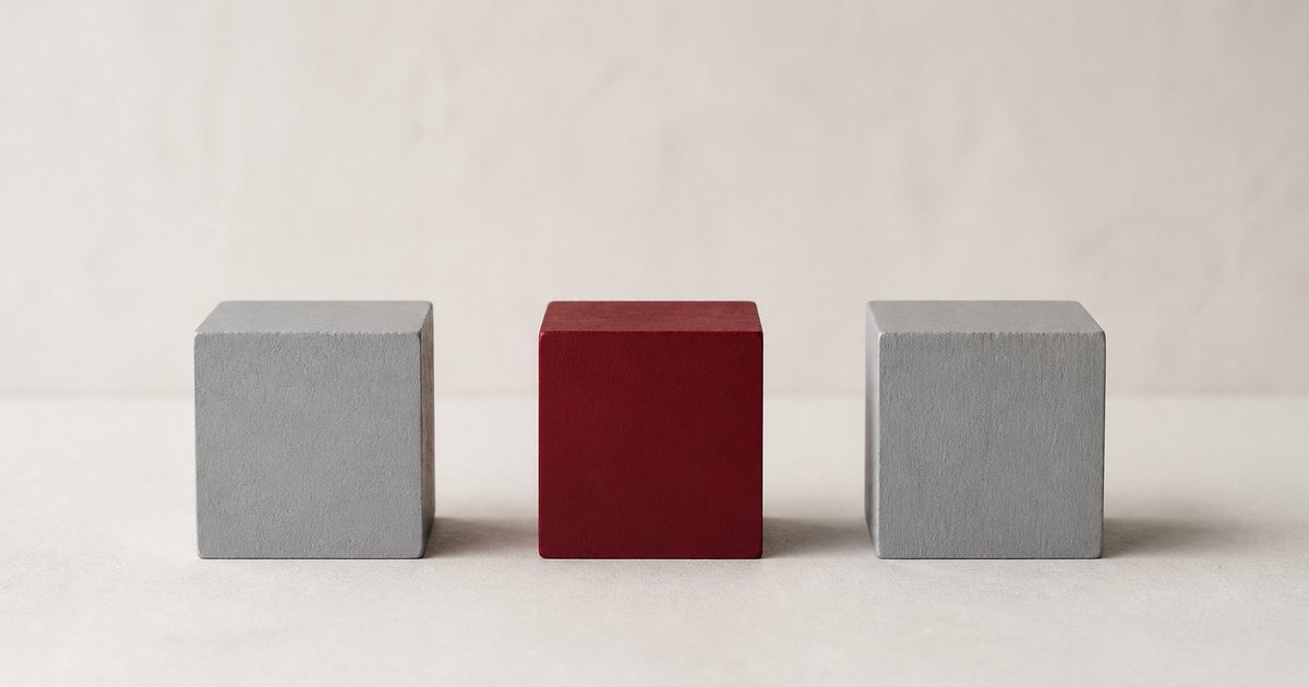 Three wooden blocks in a row with only the middle one maroon, representing one AI step inside a rules-based automation process